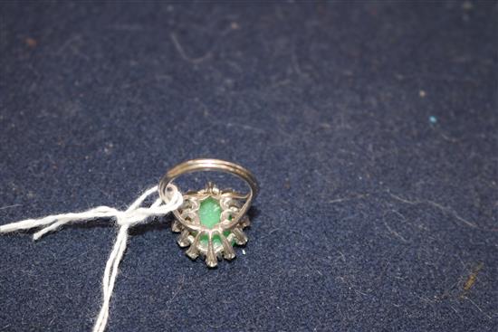 An 18ct white gold, carved oval cabochon jadeite and diamond set ring, size M.